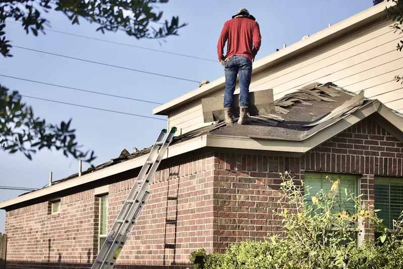Professional roofer working on a residential roof in South Platte